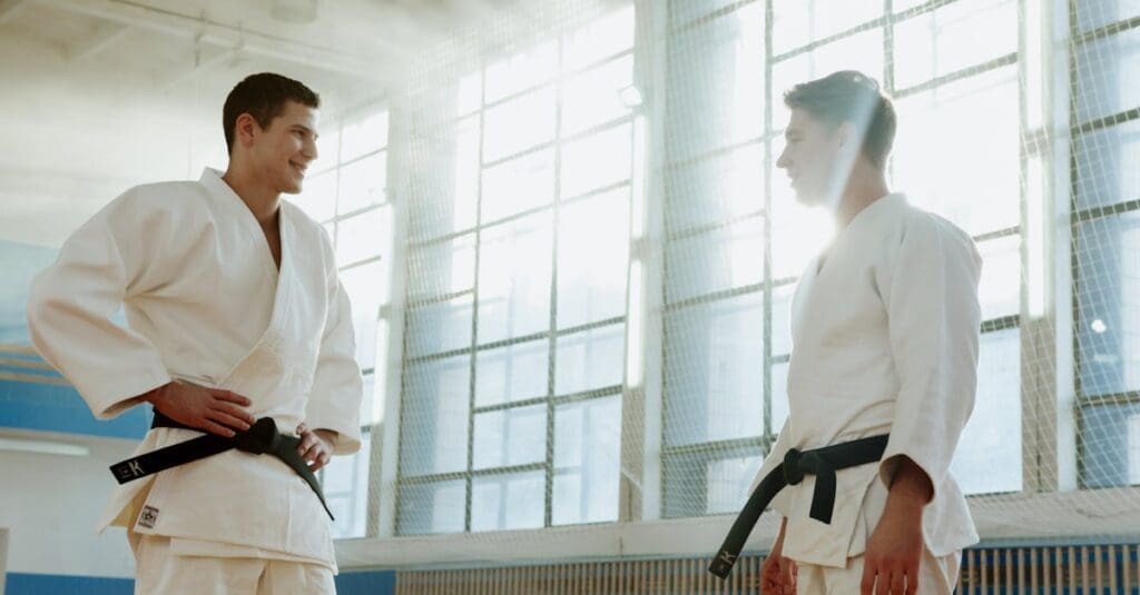 Black belt students discussing technique during martial arts for adults