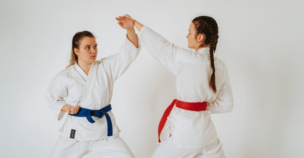 Women practicing partner blocks during beginner martial arts training