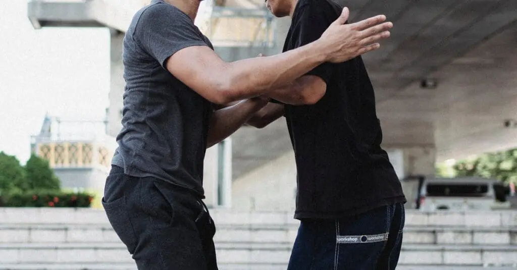 Training partners practicing close-contact positioning for defensive habits