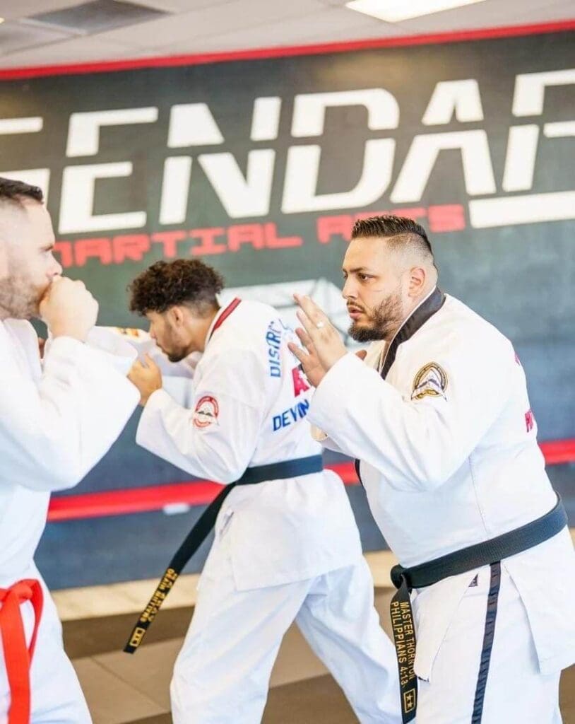 Student practicing ready stance with instructor during self defense basics training