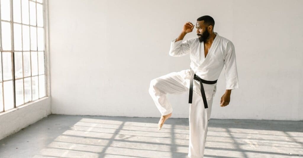 Martial artist practicing a raised-knee stance while learning personal safety basics